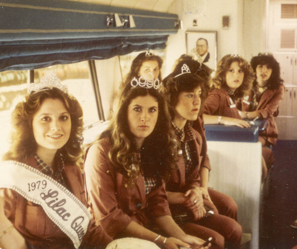 Queen Earla Schafer of North Central High along with princesses on a McDonalds bus during hospital visitation in 1979.