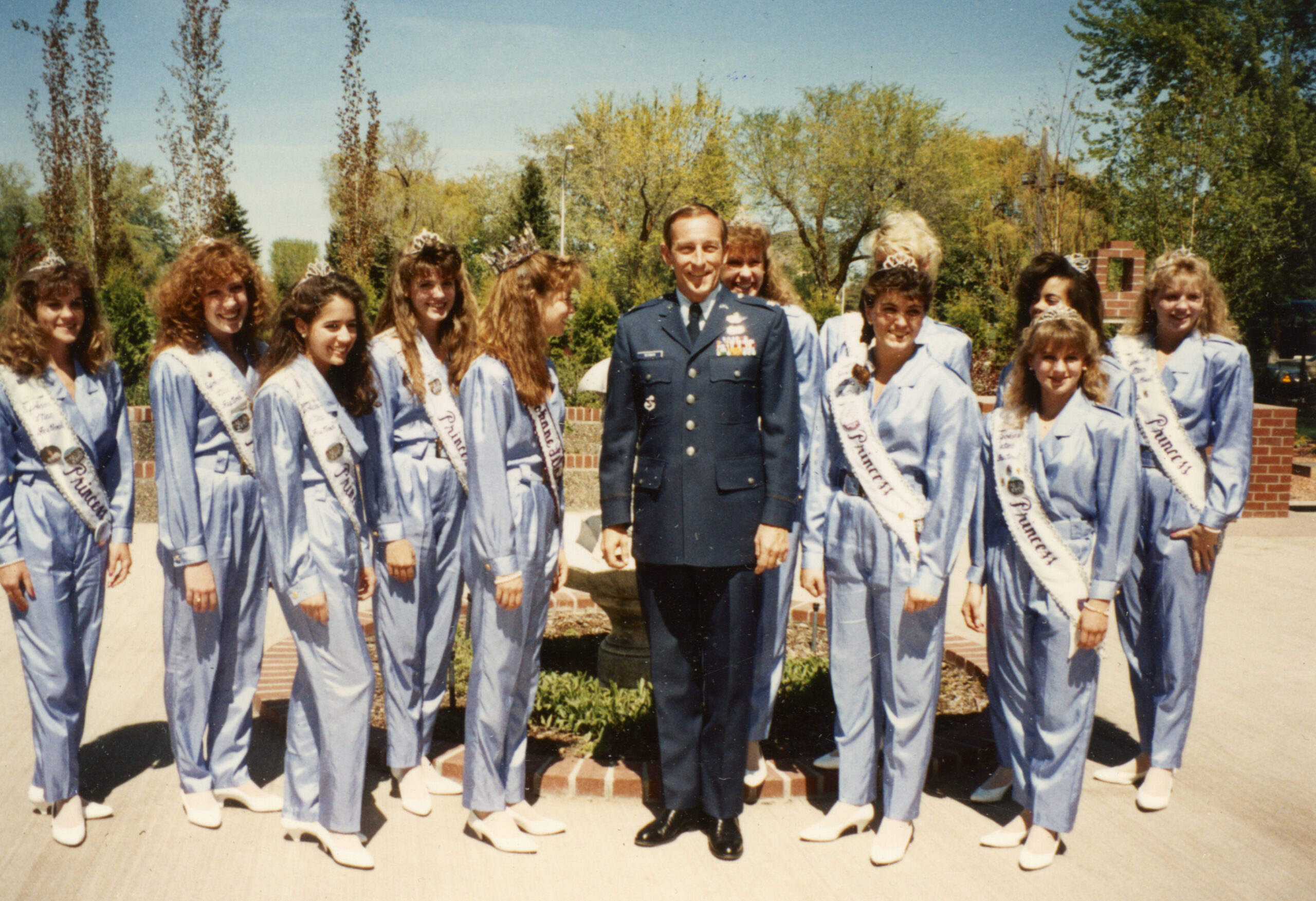 Colonel Arnie Weinman poses with Lilac royalty at Fairchild Air Force Base in 1990.